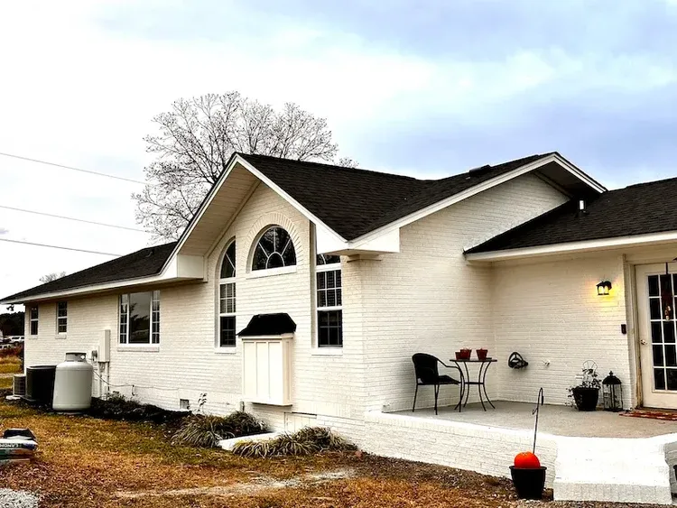 Finished residential exterior with dark roof.